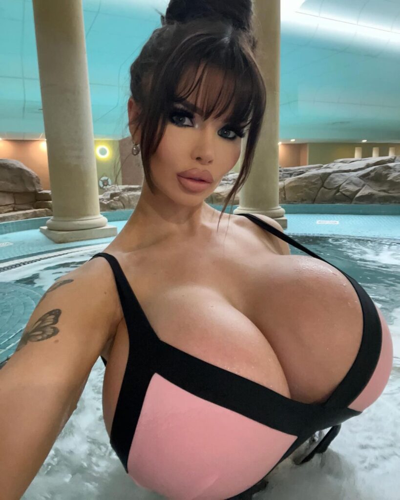 Model with huge I-cup boobs goes topless as she entices fans to buy nude pics