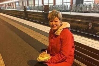 A woman is waiting for a train to return home